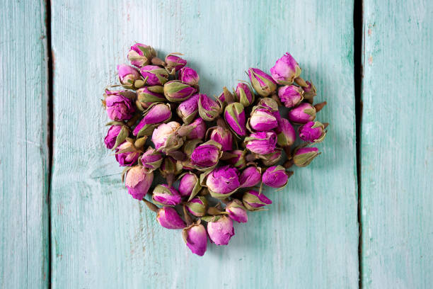 istock dried rose buds on wooden surface 1133179021