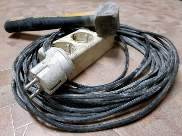 istock Electric extension and hammer on the tiled floor 1133180853