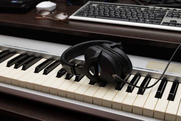 istock A break during work of composer. Headphones on the synthesizer 1133182218