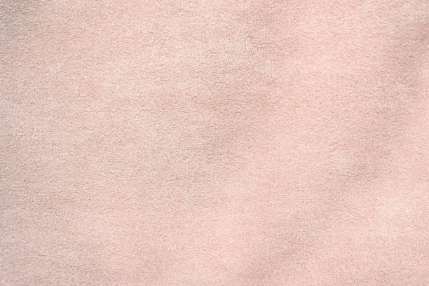 Suede is artificial. Light pink suede fabric close-up. Velvet texture background