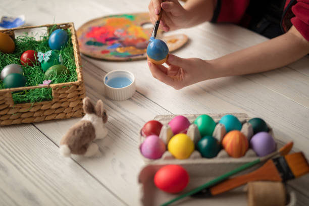 istock DIY young woman paints colorfull easter eggs 1133183626
