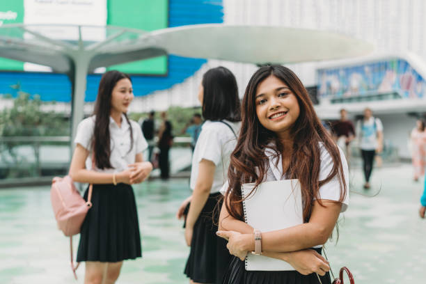 portrait of a student in the city with her friends in the background - siam square imagens e fotografias de stock