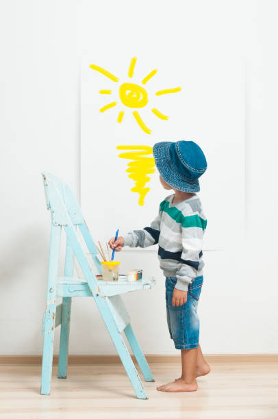 istock Happy child paints with paint. 1133184162