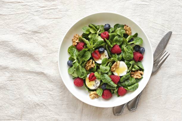 istock Green salad with goat cheese, walnuts and fresh berries 1133184918