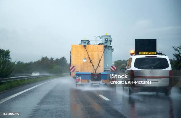 Austria Graz 09 14 2018 A Safety Escort Vehicle Following An Oversized Truck On The Motorway Stock Photo - Download Image Now