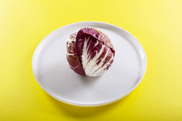 istock Red radish in the white plate on the yellow background 1133189427