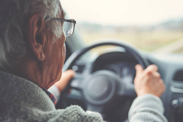 istock Old gentleman drives car 1133192248