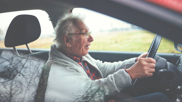 istock Old gentleman drives car 1133192382