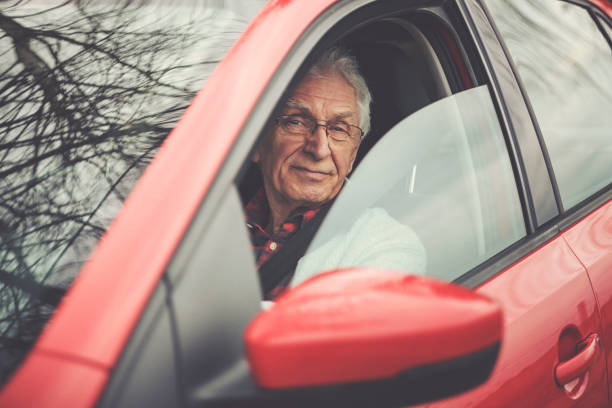 istock Old gentleman drives car 1133192605