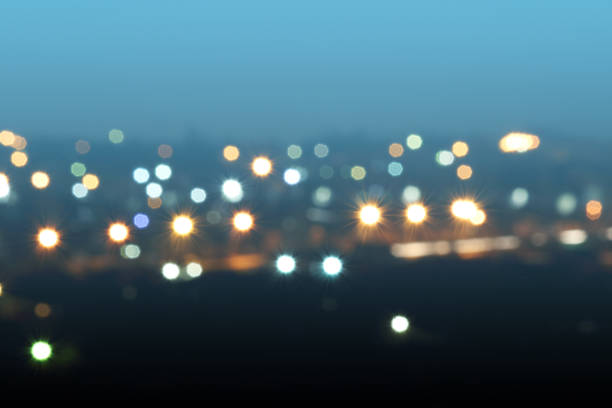 Defocused or blurred image of multi-colored lights in the city streets. Abstract background, selective focus.