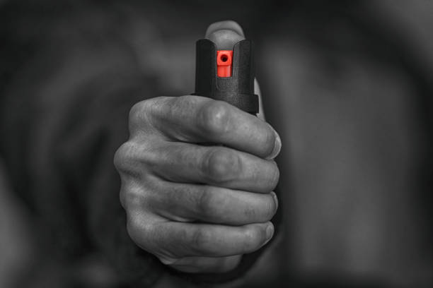 Man holding pepper spray in his hand Man holding pepper spray in his hand. tear gas stock pictures, royalty-free photos & images