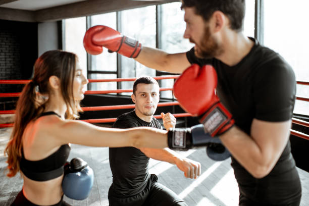 istock Couple training to box with trainer at the gym 1133199955