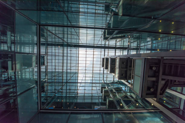 istock Modern glass elevator and pedestrian stairway entrances. 1133201034
