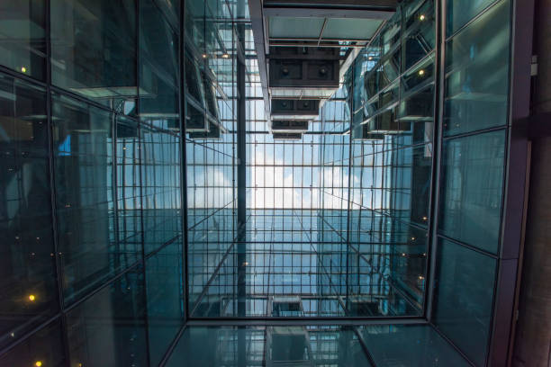 istock Modern glass elevator and pedestrian stairway entrances. 1133201440