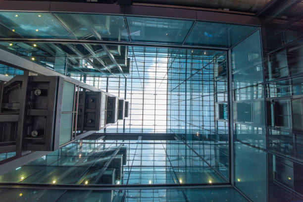istock Modern glass elevator and pedestrian stairway entrances. 1133201441