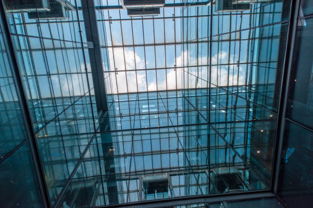istock Modern glass elevator and pedestrian stairway entrances. 1133203363