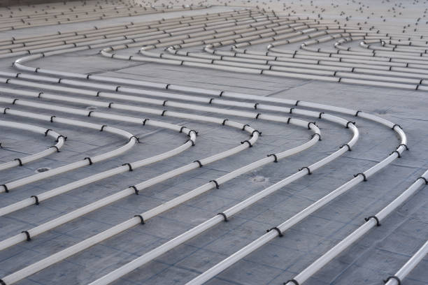 istock Underfloor heating system installation. Close up on water floor heating system interior of a new indoor swimming pool and SPA center. Plumbing pipes. Individual Heating. 1133204194