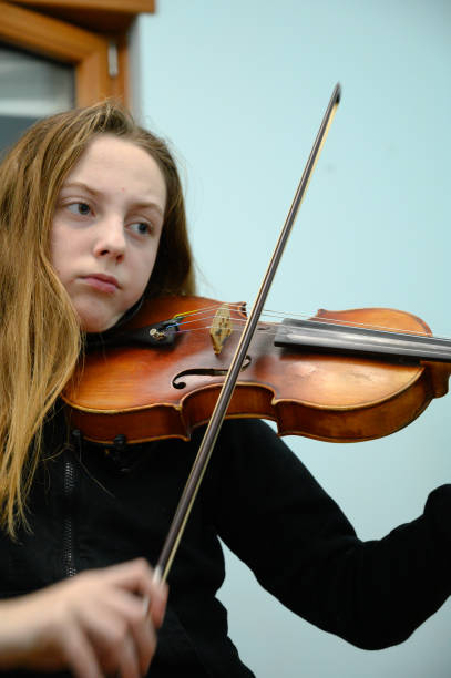istock Girl playing violin 1133205882