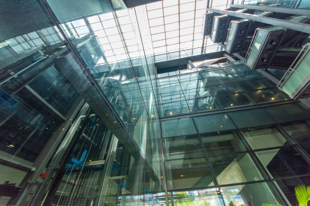 istock Modern glass elevator and pedestrian stairway entrances. 1133205978