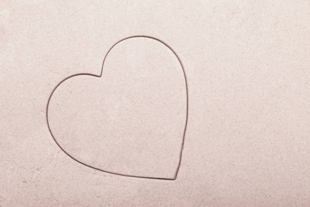 istock A single heart shape imprinted in the sand 1133209517