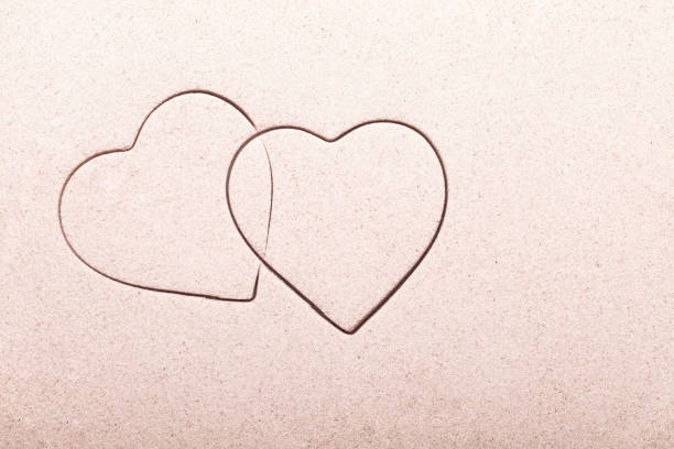 Two entwined hearts in the sand