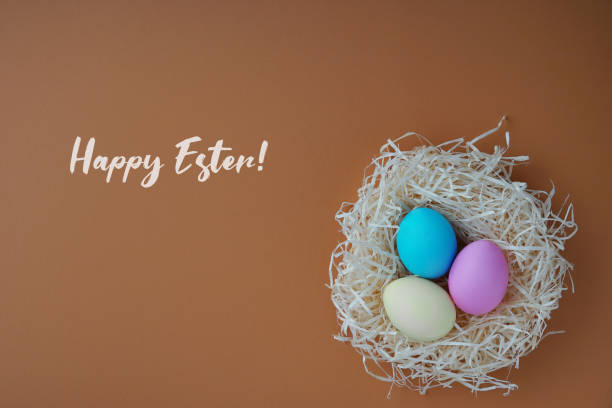 istock Happy Easter greeting card; Colored eggs in a hen nest. 1133210411