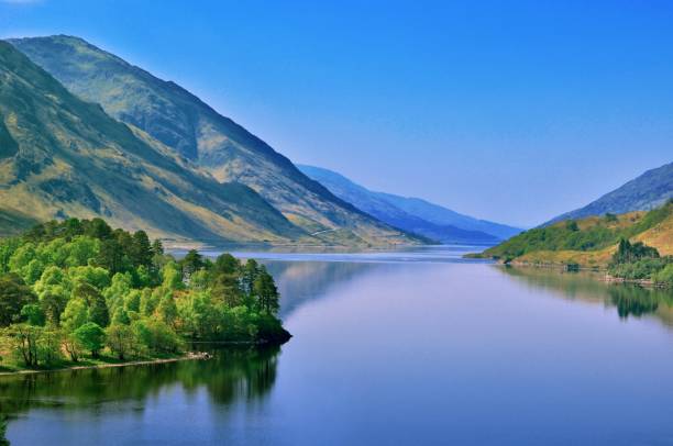 Peaceful Loch Shiel Tranquil waters on Loch Shiel on a warm spring day. fort william stock pictures, royalty-free photos & images