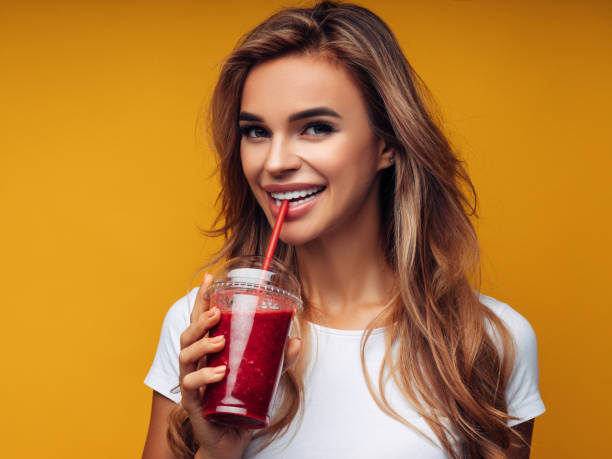 istock Beautiful girl drinks smoothies 1133211519