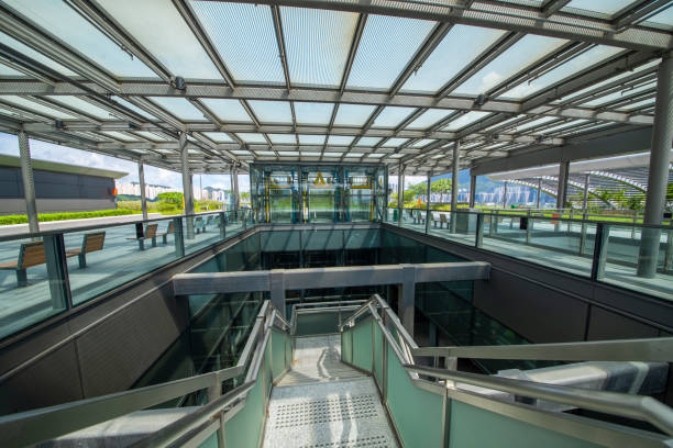 istock Modern glass elevator and pedestrian stairway entrances. 1133211579