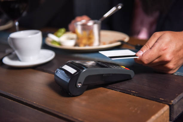 istock People paying in restaurant by credit card reader 1133211782