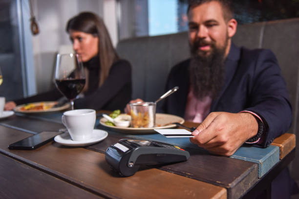 istock People paying in restaurant by credit card reader 1133211921