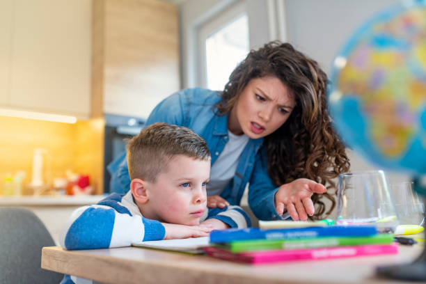 istock Mother scolds a child for poor schooling and homework at home. 1133214809