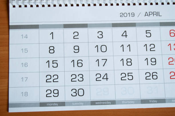 istock Background dates on the calendar page April 2019, on a wooden table 1133215502