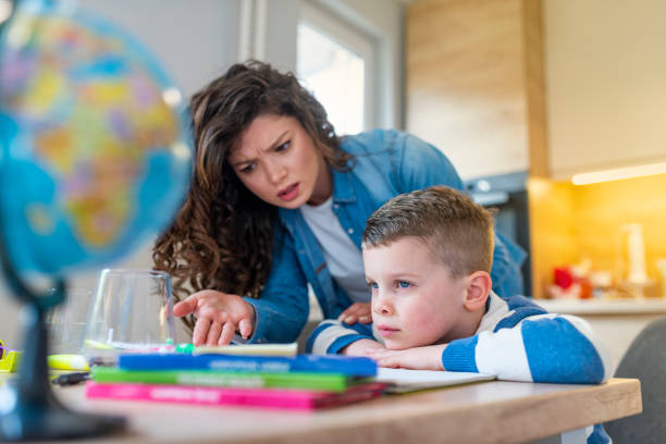 istock Mother scolds a child for poor schooling and homework at home. 1133215519
