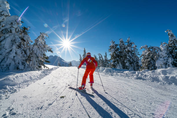istock back view skiing woman pushing on flat slope on sunny winter day 1133215965