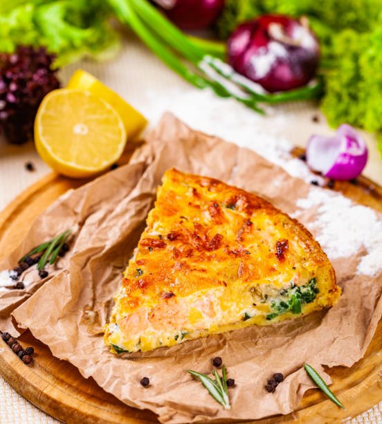 istock Pie with salmon, potato and spinach on wooden cutting board 1133217457