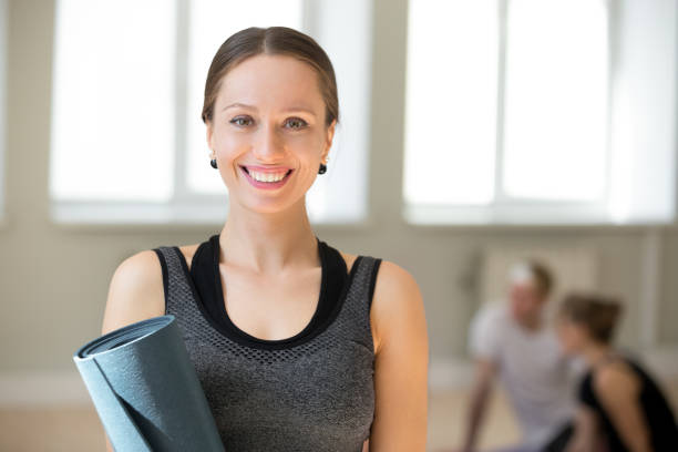 Portrait of smiling female trainer looking at camera
