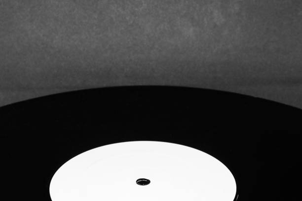 istock Background surface of vinyl LP with copy space on black background. Vinyl is in camera focus 1133219727