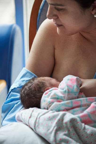 Mom hold newborn baby and breastfeeding in private hospital