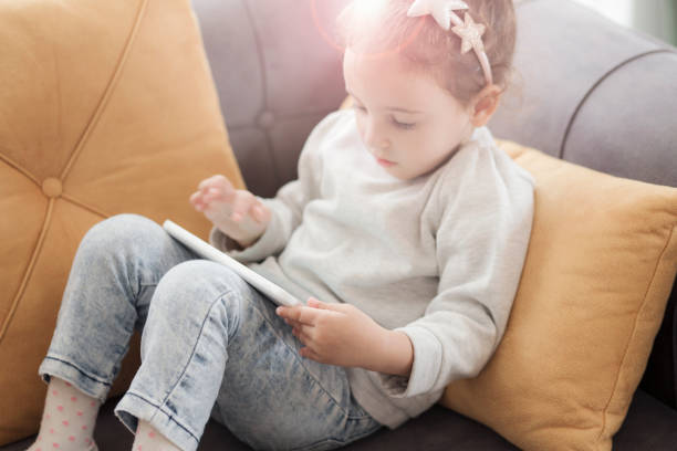 istock Cute little girl using a digital tablet 1133223250