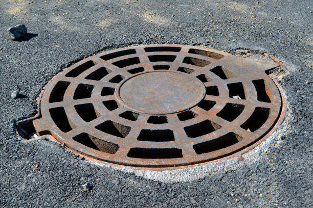 istock Cast-iron manhole cover storm sewer in the park 1133225280
