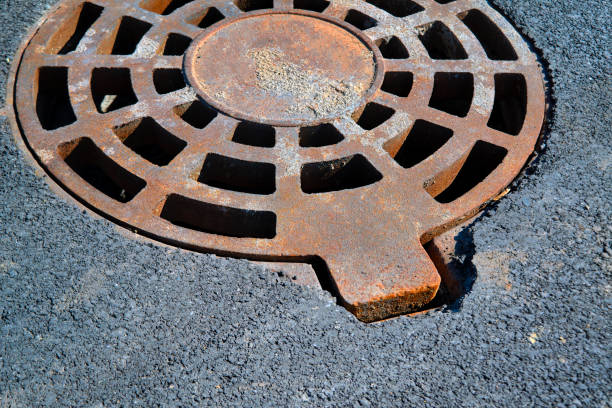 istock Cast-iron manhole cover storm sewer in the park 1133225281