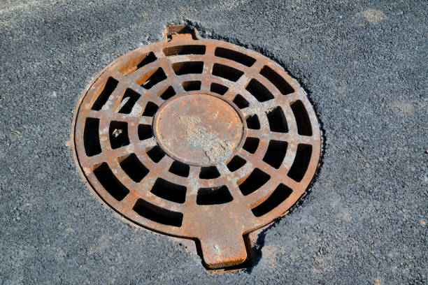 istock Cast-iron manhole cover storm sewer in the park 1133225286