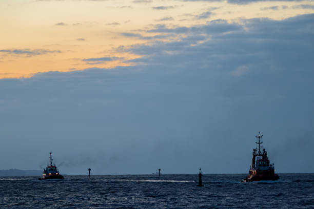 istock Tugboat returning to the port after sunset. 1133232684