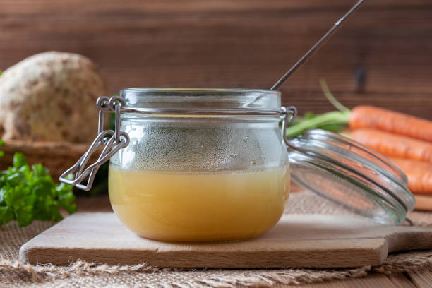 istock Chicken bone broth in a glass jar and fresh vegetables 1133236333