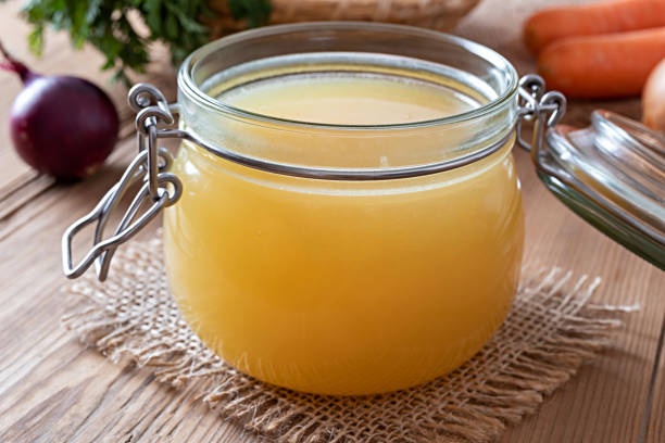 istock Chicken bone broth in a glass jar and fresh vegetables 1133236344