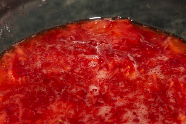 istock Making of strawberries with sugar on black table in white tile kitchen 1133236395
