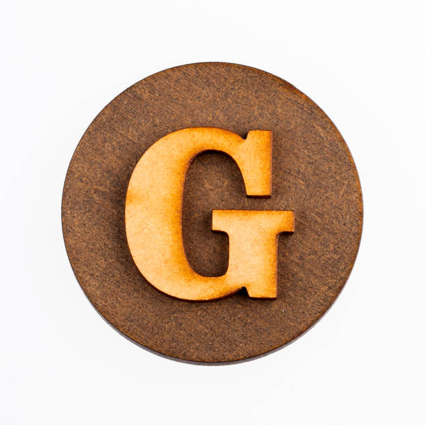 istock Letter G on a wood circle - Alphabet 1133239594