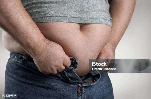 Overweight Man Trying To Wear Too Small Jeans Stock Photo - Download Image Now - Pants, People, Fastening
