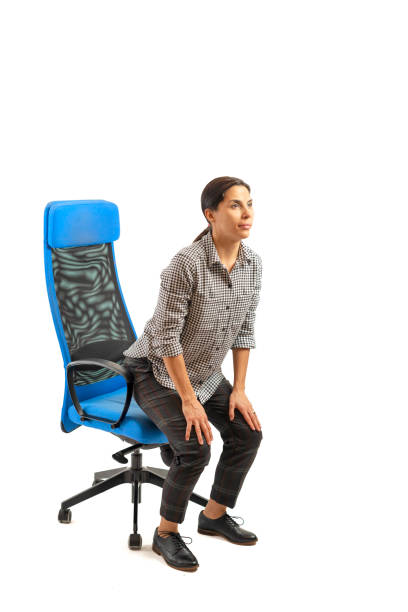 istock Woman sitting on the office chair and doing exercises. 1133242099